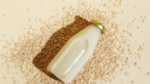 oat milk in glass bottle and oatmeal flakes on royalty free image 1712171821